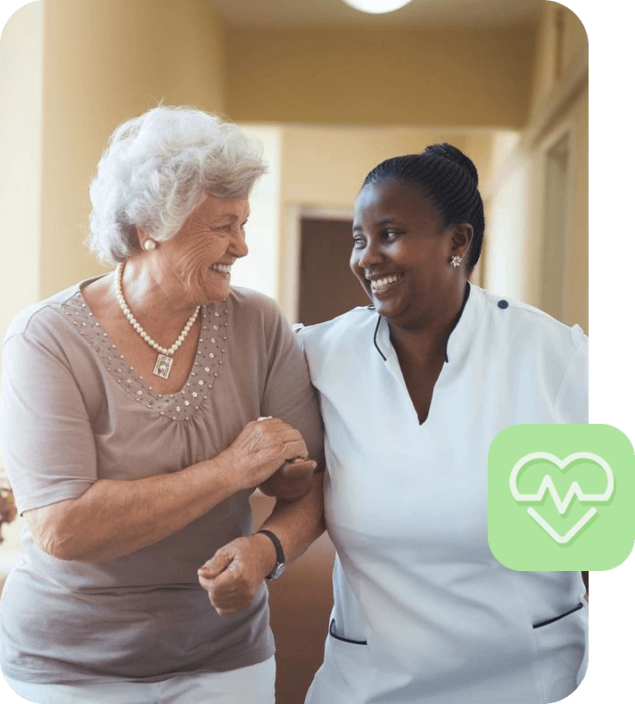 A nurse and an older woman smiling for the camera.