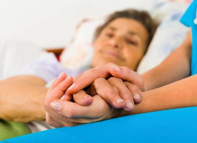 A woman holding her hands in front of another person.