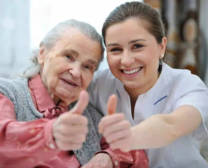 A woman and an old lady giving thumbs up